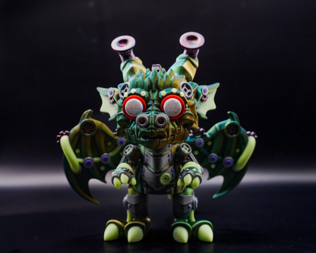 3D printed articulated dragon-robot monster figure with wings and red eyes, close-up front view
