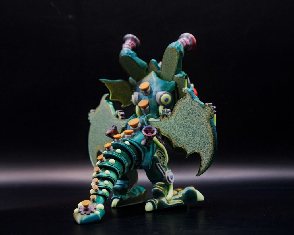 3D printed articulated dragon-robot monster figure with wings, side angle